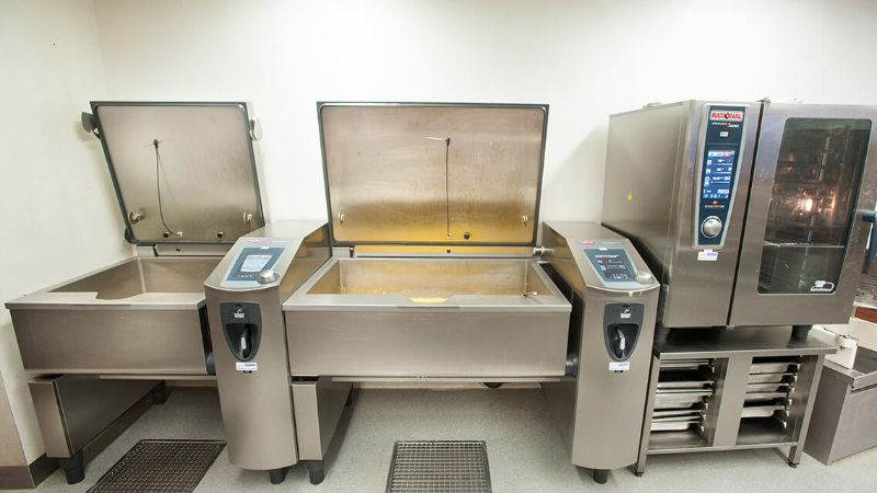 Modern commercial kitchen equipment with Rational combi oven and two VarioCookingCenter.
