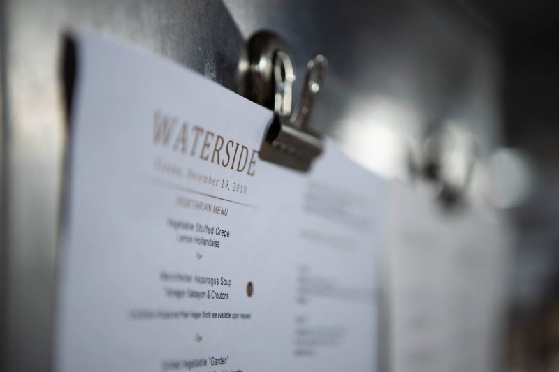 A close-up of a vegetarian menu pinned to a board, titled 