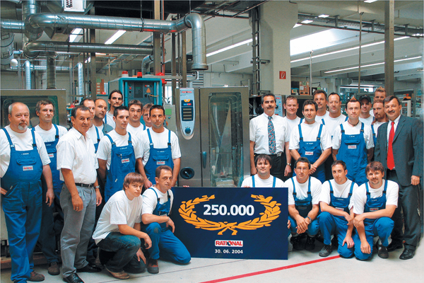 Large group photo of RATIONAL employees gathered in a production hall to celebrate a milestone.