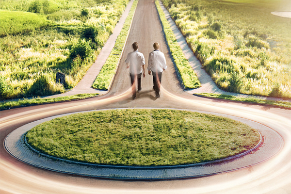 Two people walking the same path from a roundabout – symbol of shared vision and common goals.