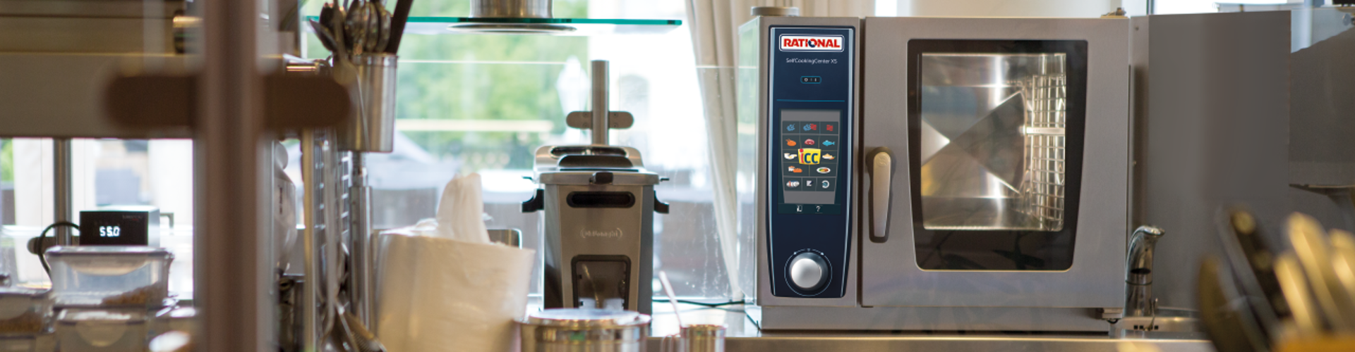 Open restaurant kitchen with a SelfCookingCenter XS on the counter.